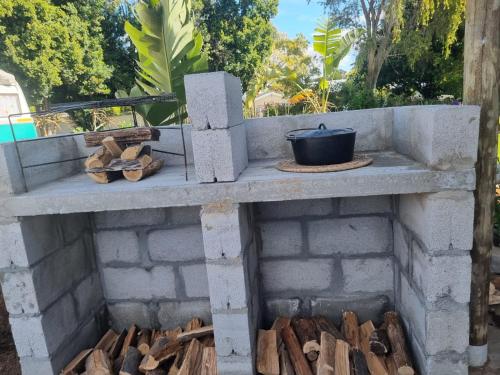 a brick oven with a pot on top at Angel 8 AirBnB Apartment 2 in Robertson