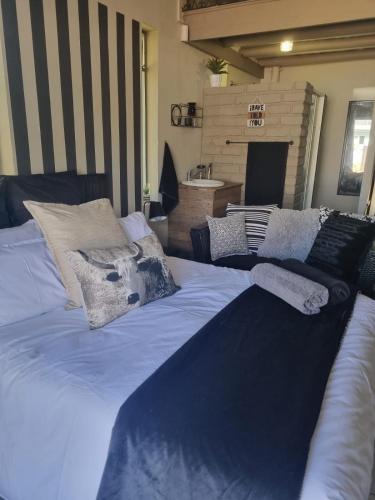 a large blue bed with pillows on top of it at Angel 8 AirBnB Apartment 2 in Robertson