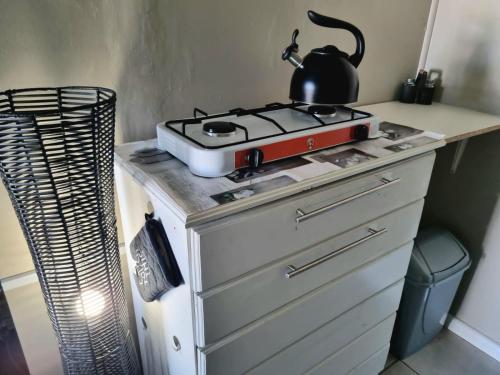 a stove with a tea kettle on top of it at Angel 8 AirBnB Apartment 2 in Robertson