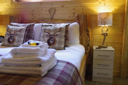 a bedroom with a bed with towels on it at The Windsor Lodge in Ellesmere
