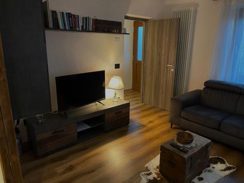 salon z kanapą i telewizorem z płaskim ekranem w obiekcie Casa Rodi w mieście Siror