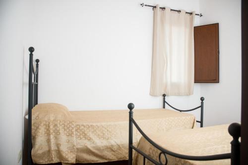 a bedroom with two beds and a window at Hotel Donna Carmela Sede Unica a Sciacca in Sciacca
