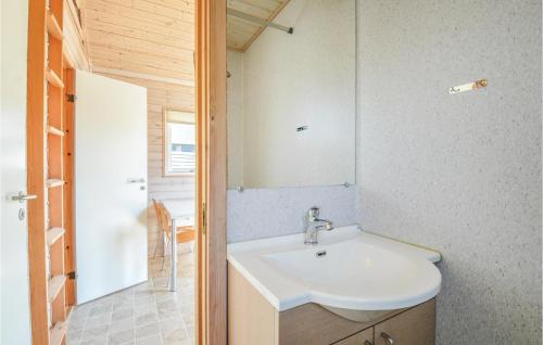 a bathroom with a sink and a mirror at Hytte 8 in Thyborøn