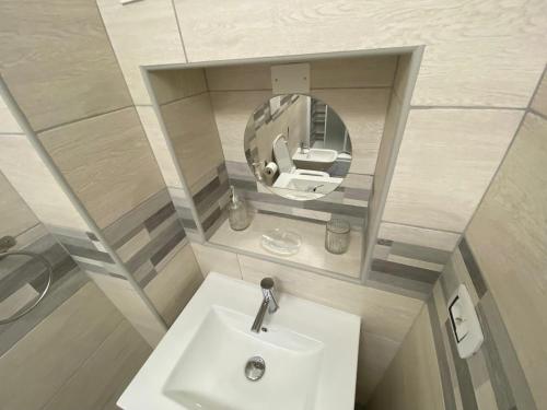 a small bathroom with a sink and a mirror at Casaiole2023 in Taranto