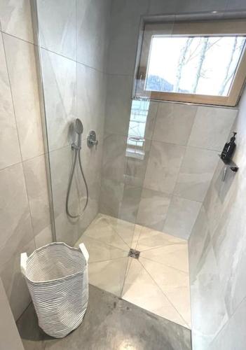 a bathroom with a shower with a glass door at KampenZeit Loft mit traumhaftem Panoramablick in Aschau im Chiemgau