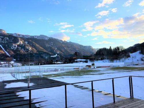 a snow covered field with mountains in the background at KampenZeit Loft mit traumhaftem Panoramablick in Aschau im Chiemgau