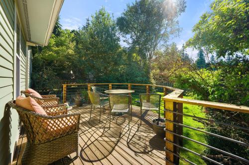 a wooden deck with a table and chairs on it at Geneva Retreat in Bellingham