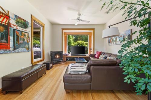 a living room with a couch and a fireplace at Geneva Retreat in Bellingham