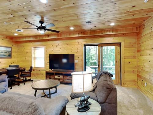 a living room with a couch and a television at Alpine Valley in McHenry
