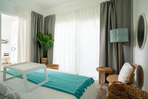 a bedroom with a bed with a table and chairs at Casa Loba Suite 4 with private pool in Rincon