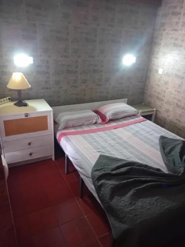 a small bedroom with two beds and a night stand at T1 N 93 Ref 001 in Tavira