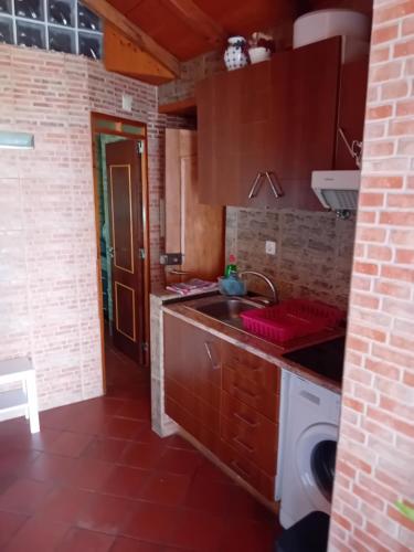 a kitchen with a sink and a washing machine at T1 N 93 Ref 001 in Tavira