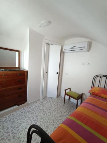 a bedroom with a bed and a dresser and a mirror at Sull'arco della Gnostra in Noci