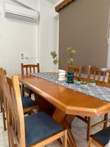 a dining room with a wooden table and chairs at Bacchus Villa in Archea Pissa