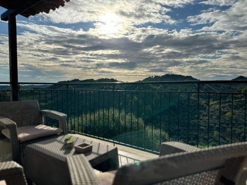 a balcony with a view of the mountains at Bacchus Villa in Archea Pissa