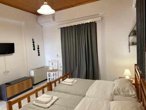 a bedroom with a bed with two towels on it at Bacchus Villa in Archea Pissa
