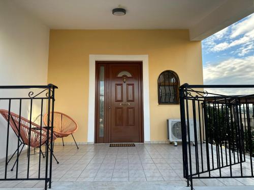 a front door of a house with a chair at Bacchus Villa in Archea Pissa