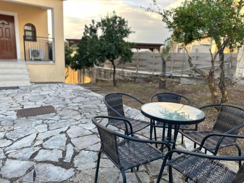 a table and chairs on a stone patio at Bacchus Villa in Archea Pissa