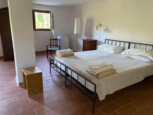 a bedroom with two beds with towels on them at The Sanctuary by Caimeli in Umbertide