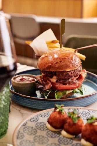 a sandwich on a plate on a table at The Level at Melia White House in London