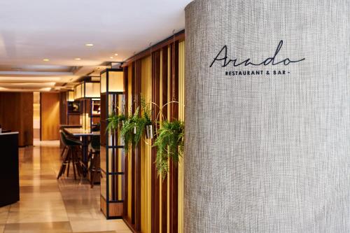 a sign for ananda restaurant and bar in a lobby at The Level at Melia White House in London