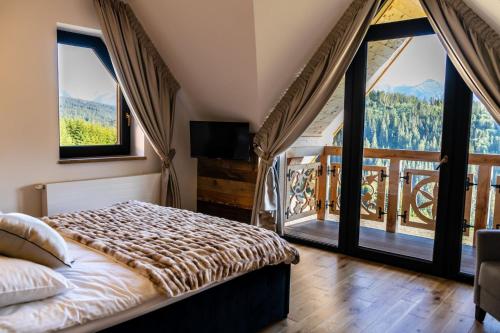 En eller flere senge i et værelse på Buńdowe Wzgórze domki na wynajem