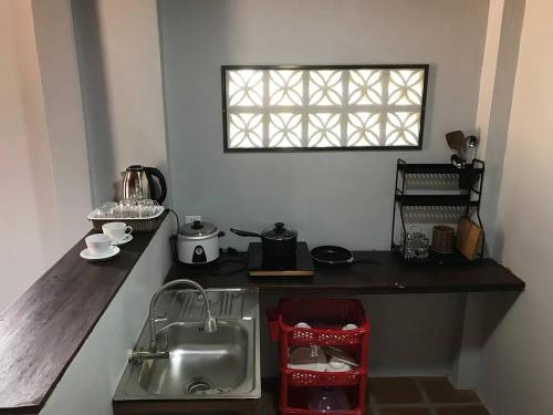 a kitchen counter with a sink and a window at Apsara Khmer House in Siem Reap