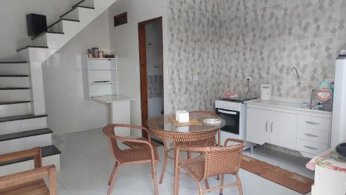 een kleine keuken met een tafel en stoelen in een kamer bij Residencial Maria de Lourdes in Ibicoara