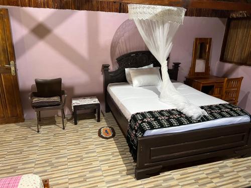 En eller flere senger på et rom på Lualemba Bungalows