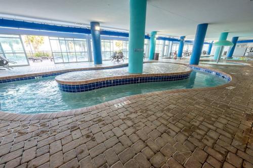 a swimming pool in the middle of a building at Low Floor,Direct Oceanfront,Heated Pool,Boardwalk! in Myrtle Beach