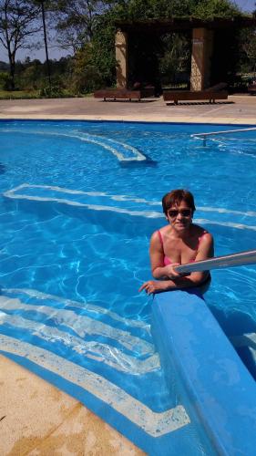 a woman in a swimming pool wearing sunglasses at Quincho la querencia in Apóstoles