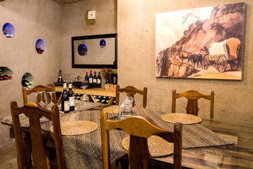 a restaurant with tables and chairs and a painting on the wall at Ezulwini Game Lodges in Balule Game Reserve