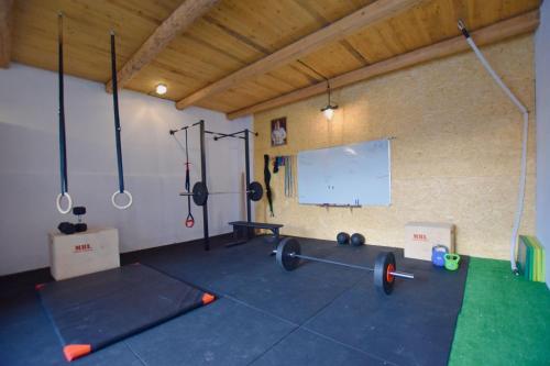 a gym with two balls and weights in a room at Pod Lubogoszczem in Mszana Dolna