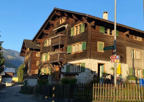 a large wooden building with balconies on a street at Casa Vegana in Trun