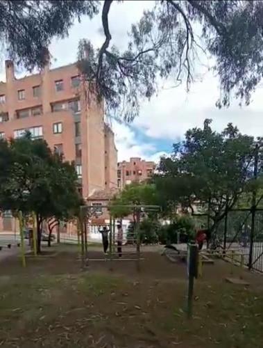 a park with a playground in front of a building at Cómoda y muy bien ubicada in Bogotá