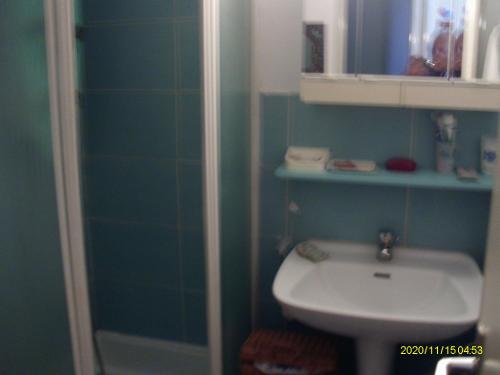La salle de bains est pourvue d'un lavabo, de toilettes et d'un miroir. dans l'établissement torres, à Villecresnes