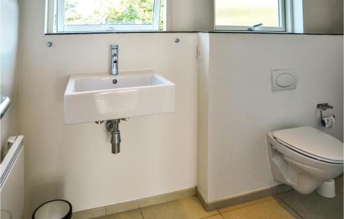a bathroom with a sink and a toilet at West-side in Søndervig