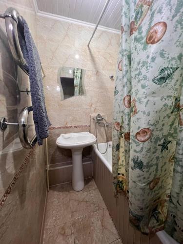 a small bathroom with a toilet and a sink at 15 Apartments in Shymkent