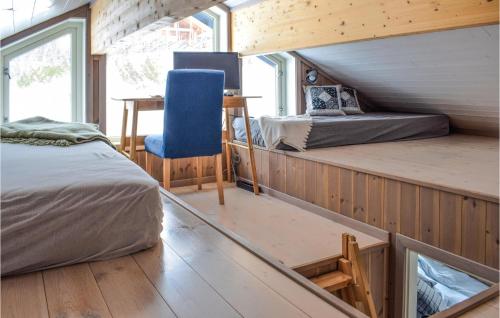 a bedroom with two beds and a blue chair at Awesome Home In Etnedal With House A Mountain View in Etnedal