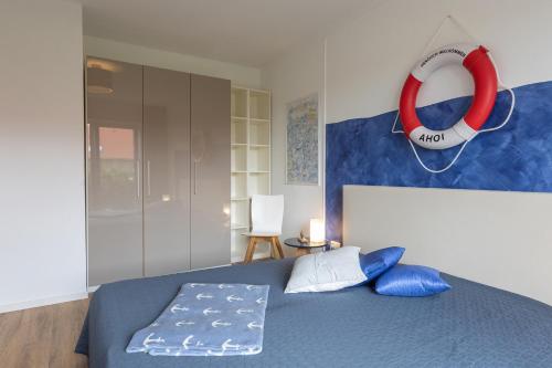 a bedroom with a bed with a lifesaver on the wall at LM 9-1-2 - Ferienwohnung Wremer Bogen Komfort in Schottwarden