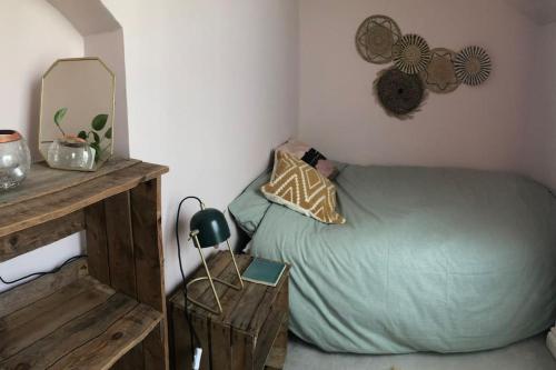 a bedroom with a green bed and a mirror at Beautiful, well positioned flat in Clifton Wood in Bristol
