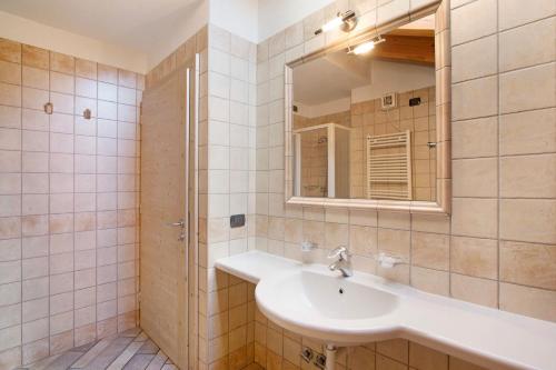 a bathroom with a sink and a mirror at Appartamento 8 in Livigno