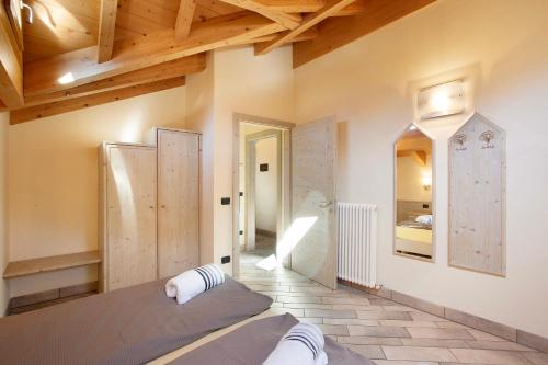 a bedroom with a bed in a room with wooden ceilings at Appartamento 8 in Livigno