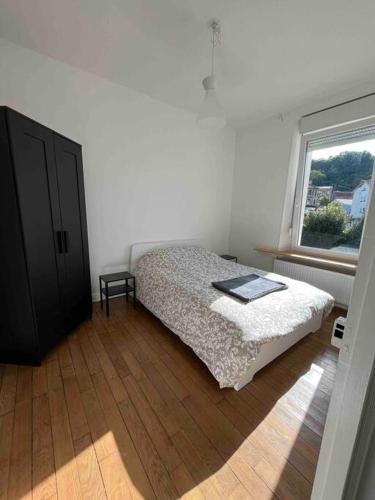 a bedroom with a bed and a window at Maison calme à proximité des 3 frontières in Longuyon