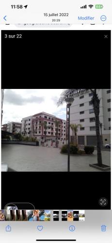 a picture of a building with a palm tree at Mohammedia Nassim résidence Galia 