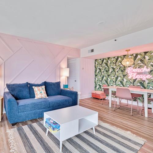 a living room with a blue couch and a table at Beach Please condo 2 bedroom 2 bath sleeps 6 in Gulf Shores