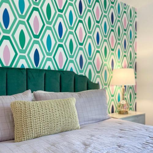 a bedroom with a bed with a green head board at Beach Please condo 2 bedroom 2 bath sleeps 6 in Gulf Shores