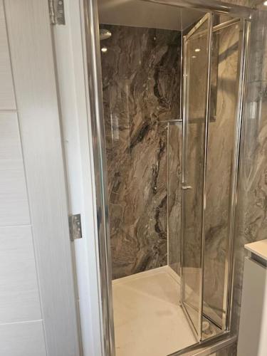 a shower with a glass door in a bathroom at Carlisle City Centre. The Foremans Residence. in Carlisle