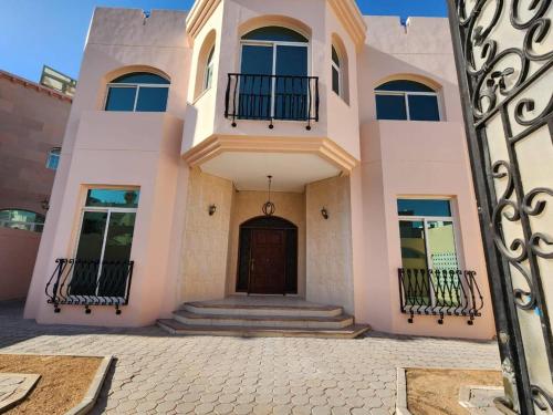 a house with a gate in front of it at Budget Backpackers Hostel in Abu Dhabi