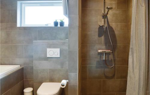 a bathroom with a shower with a toilet and a sink at Cozy Home In Rm With Wifi in Sønderby
